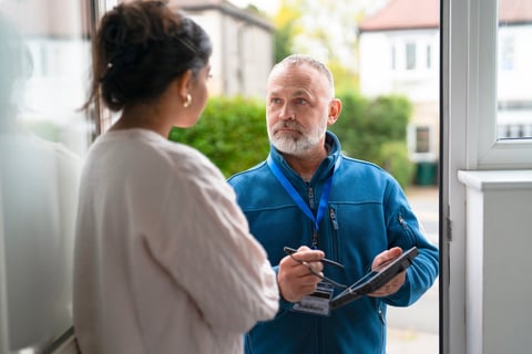 Service professional helping homeowner at doorway