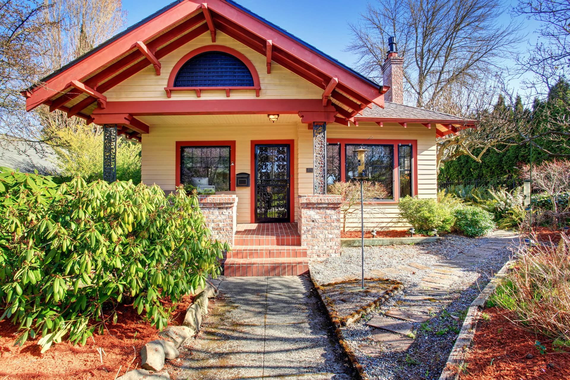 Beautiful craftsman style home with red trim and garden area, older home with character